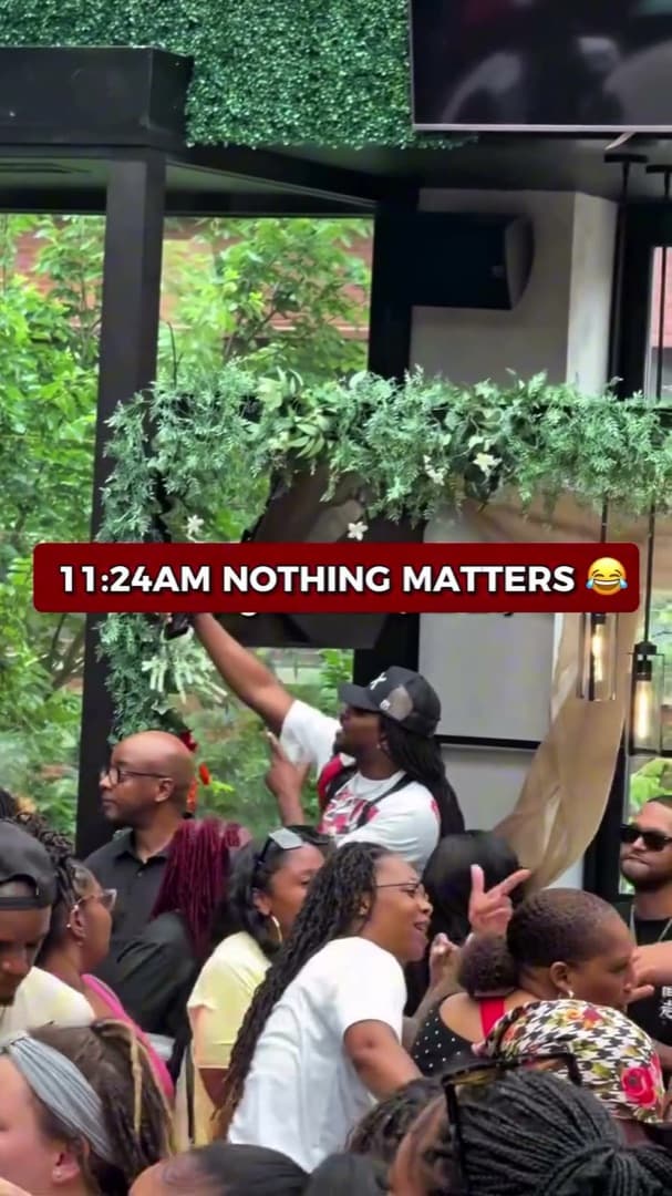 11:24 AM at a past 9AM day party — packed patio crowd with phones up under the greenery